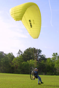 Powered paraglider pilot doing a leg drag at the EAA Sun N Fun Convention.